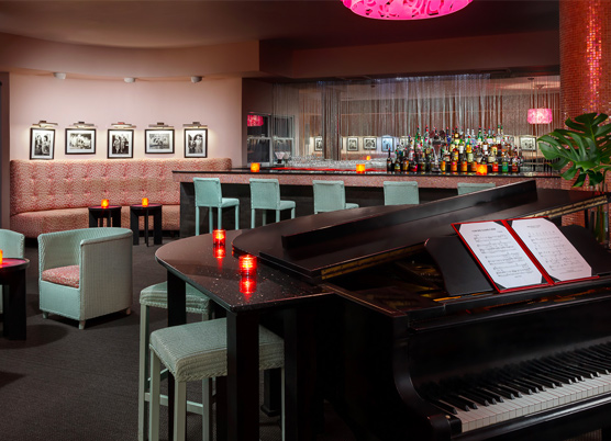 piano with an attached bar with small candles at a piano bar