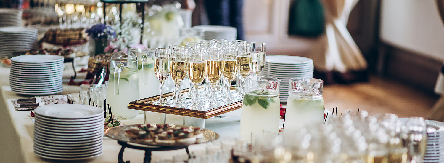 a bride and groom each holding a glass of champagne