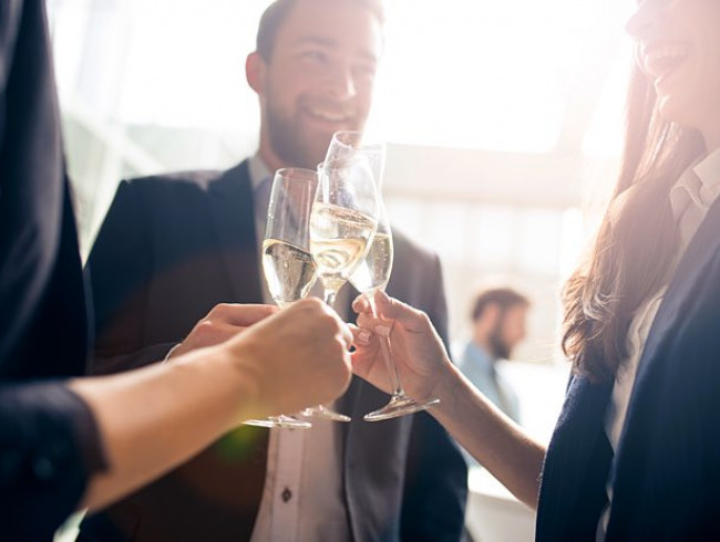 people clinking wine glasses
