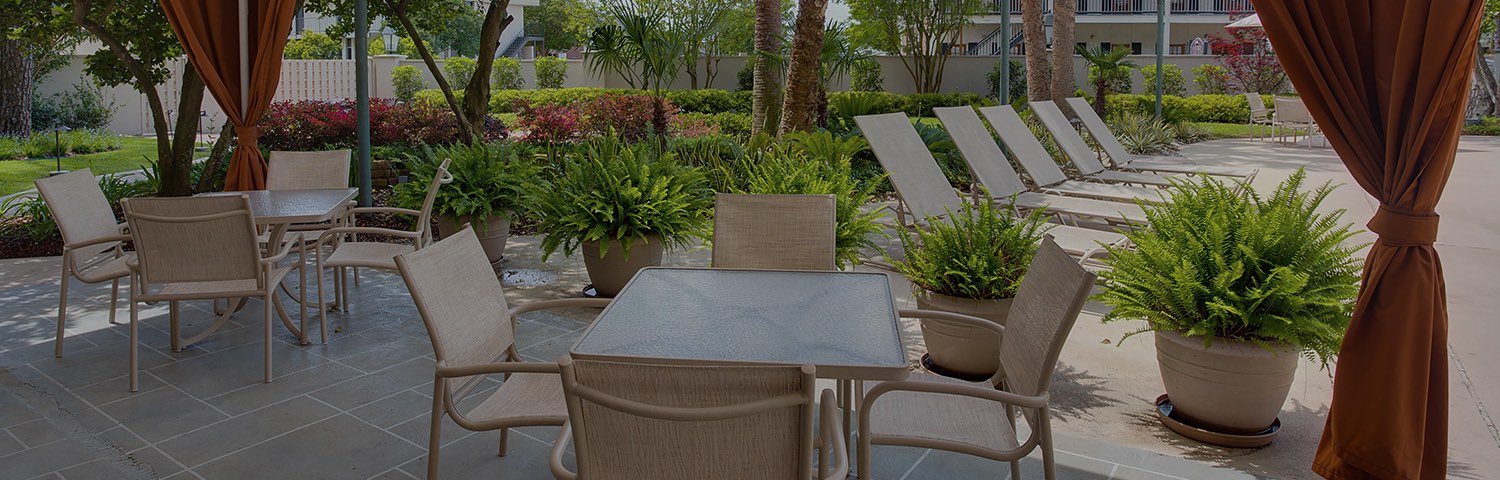 white table with tan chairs by the pool