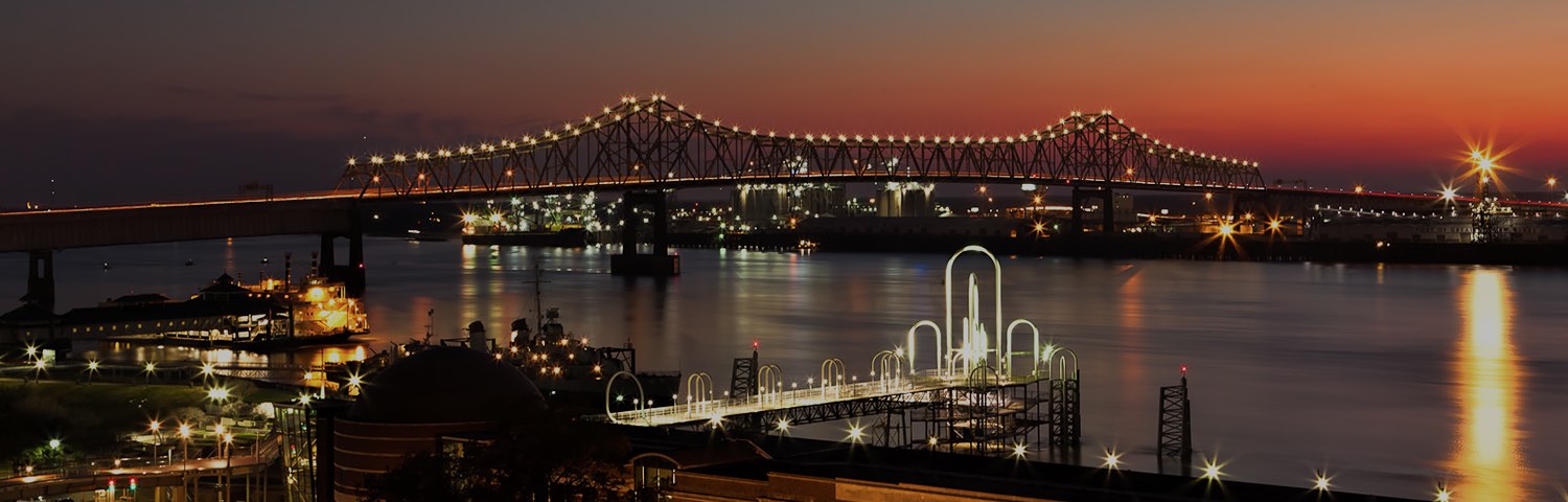 brown bridge with lights on top at sunset