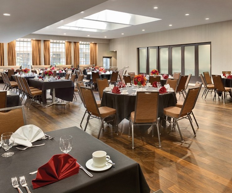 Event space set for special occasion with black table clothes and red accent details  