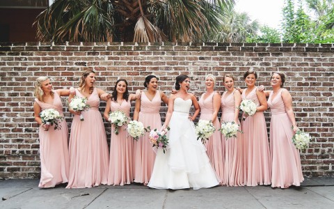 a bride with her bridesmaids posing for pictures