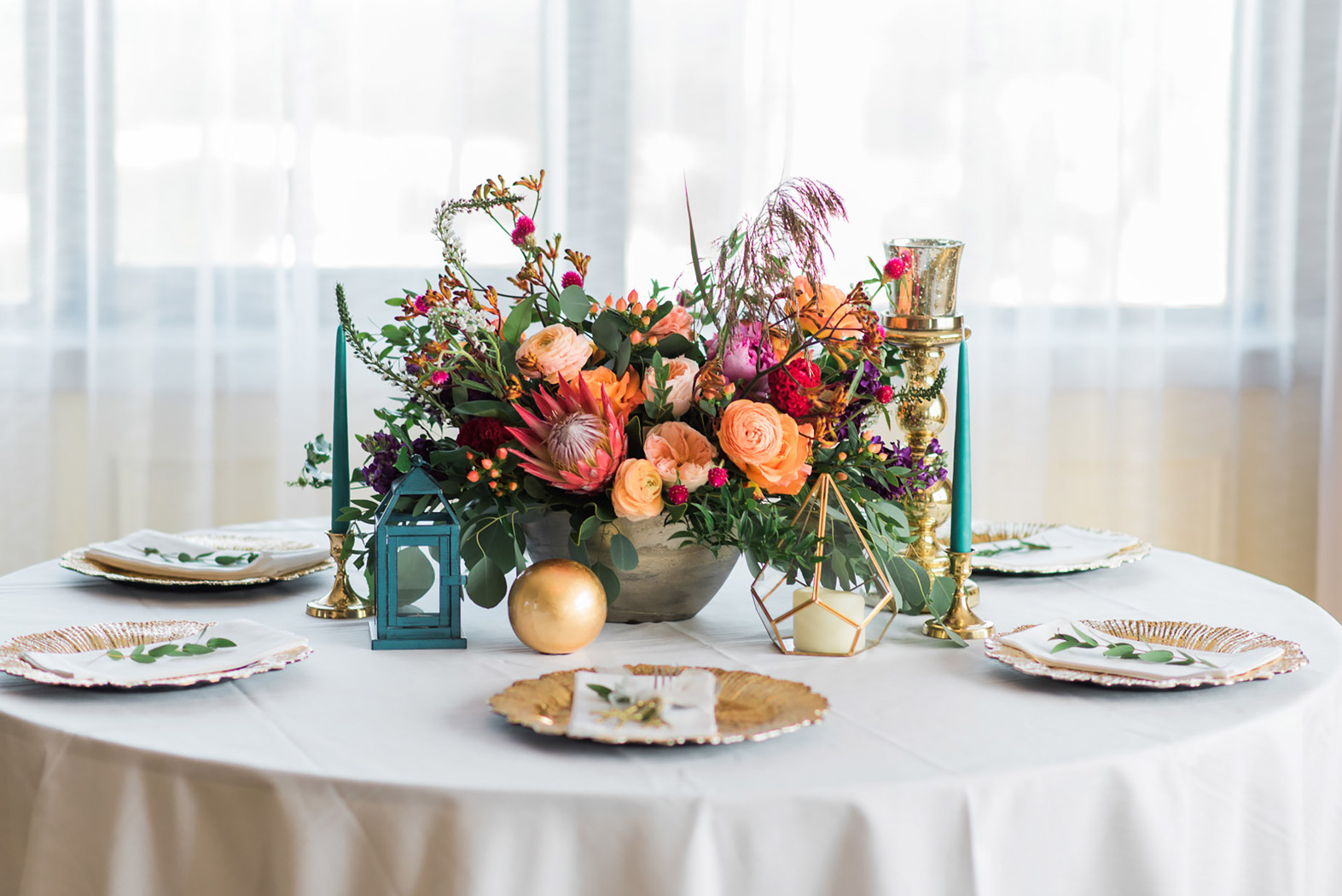 a white table with colorful floral centerpiece