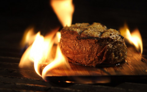 Steak being cooked over fire