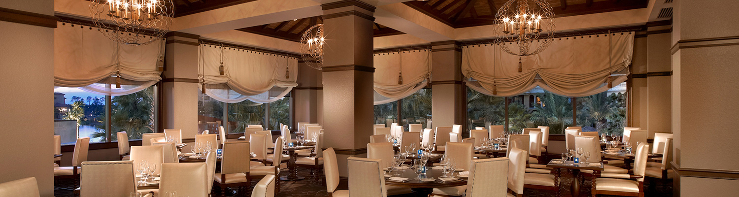 Layout of restaurant with wooden tables and white chairs