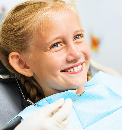 Small girl laying down with blue dentist bib