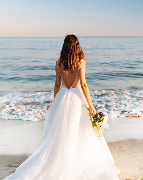 bride on the beach looking off into the distance