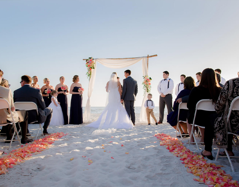 bride and groom having their ceremony at the beach 