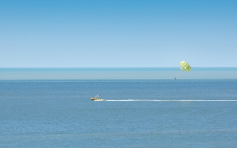 Person parasailing above the water