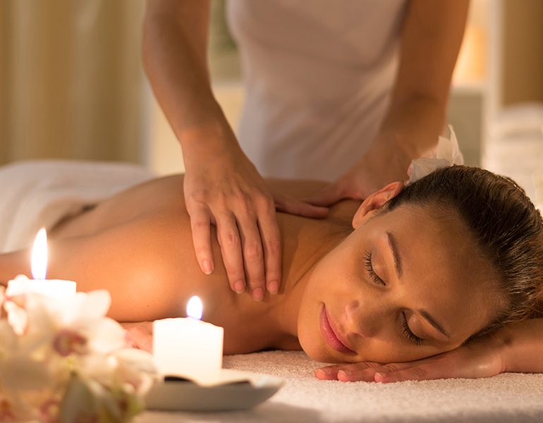 A woman getting a shoulder massage at the spa