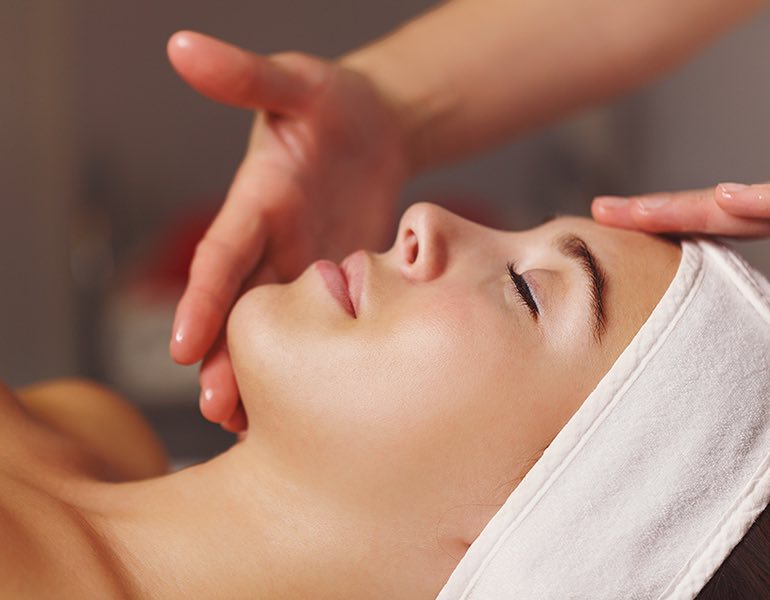 A woman getting a facial treatment