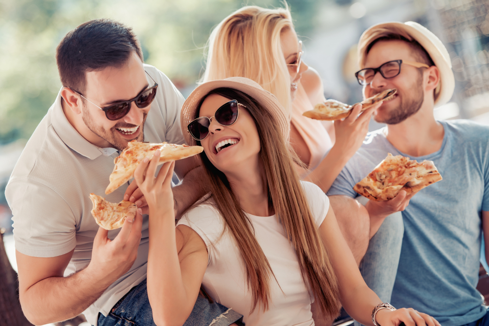 friends eating pizza together