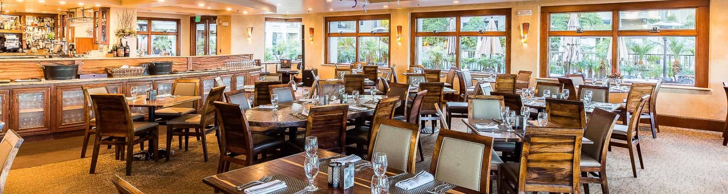 hotel dining area with many square dining tables
