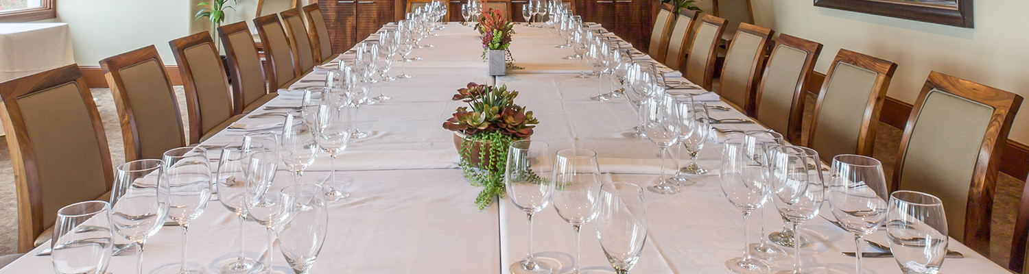 table set for an event with flowers and glassware