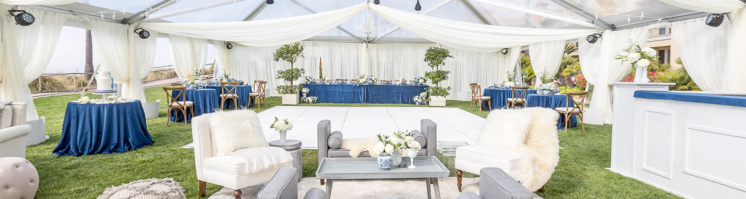 inside a wedding tent with blue and white decor