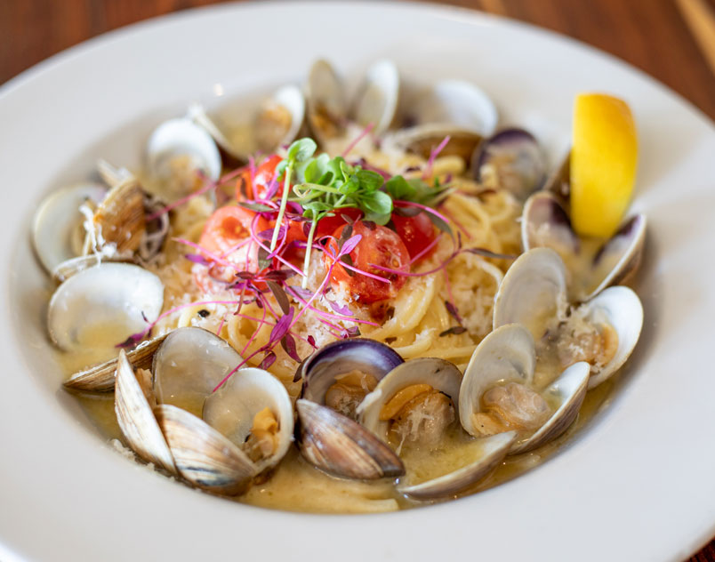 clams in pasta dish with garnish