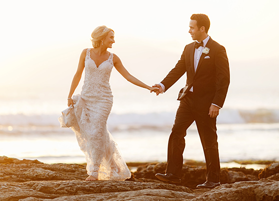 newlyweds walking on the beach