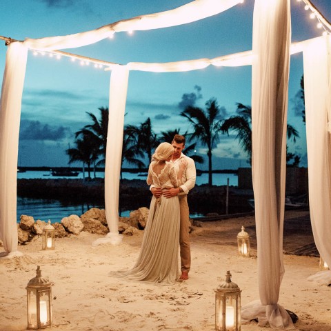 bride and groom dancing under the night sky and twinkly lights