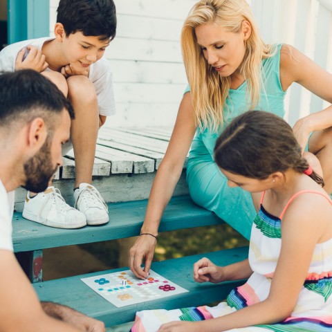 family of 4 playing a boardhame