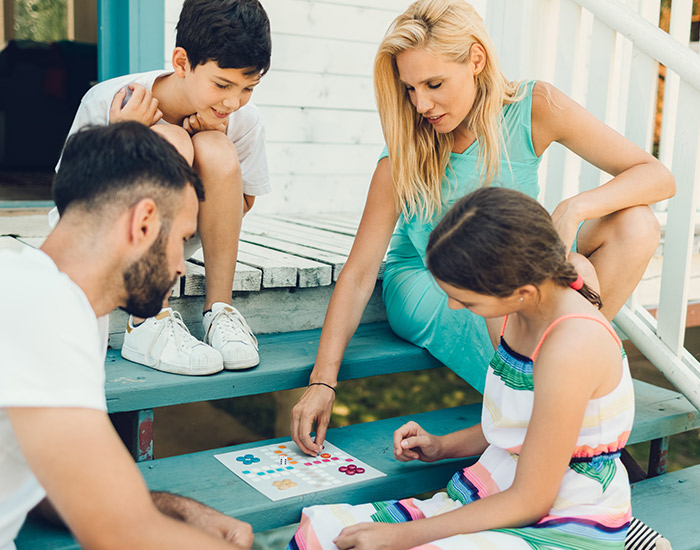 family of 4 playing a board game