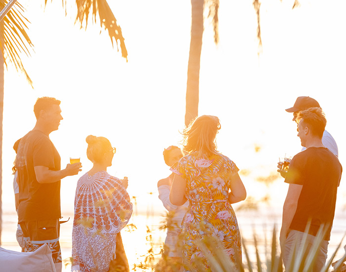 friends having drinks and watching a sunset