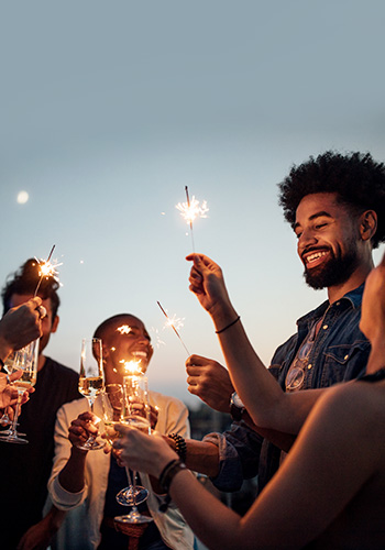 friends having fun with sparklers at night