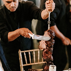 man cutting picanha at an event