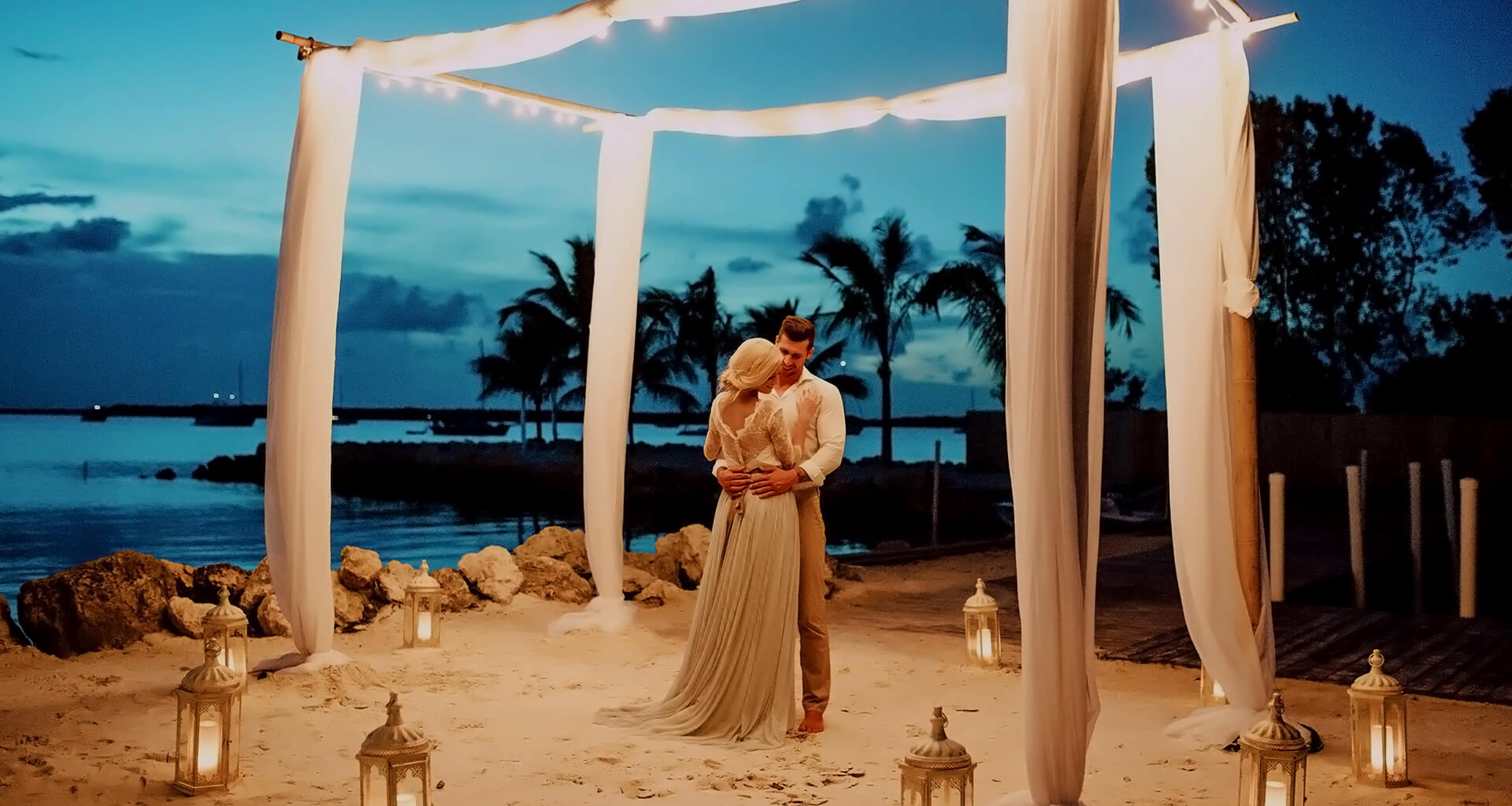 bride and groom dancing under the night sky and twinkly lights
