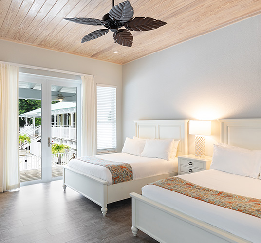 two beds a high ceiling fan