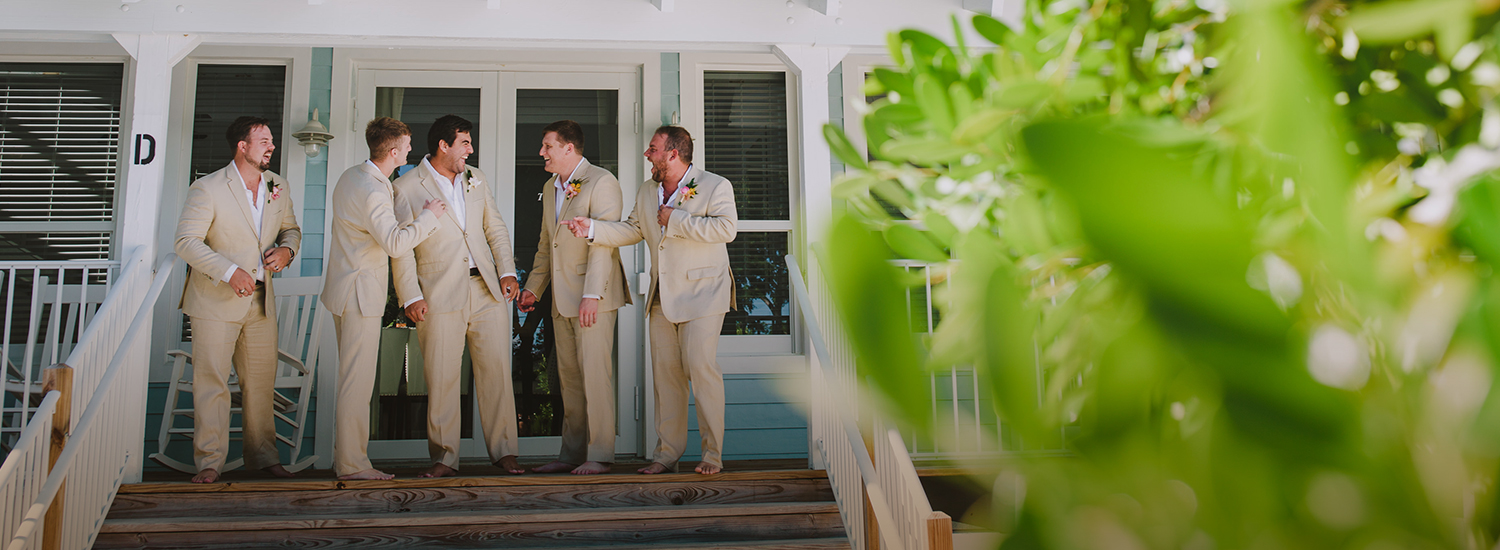 groomsmen having fun outside a villa