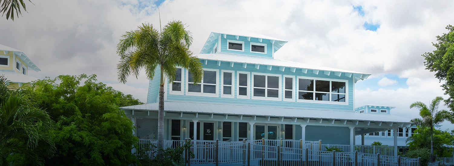 exterior of blue hotel on a sunny day