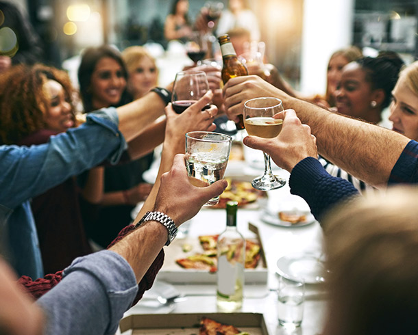 large group around a table making a toast
