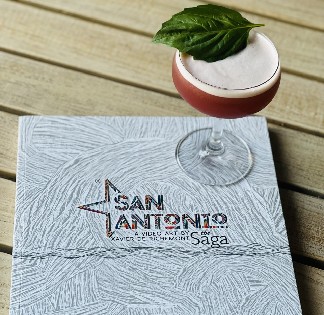book with cocktail on top for book signing