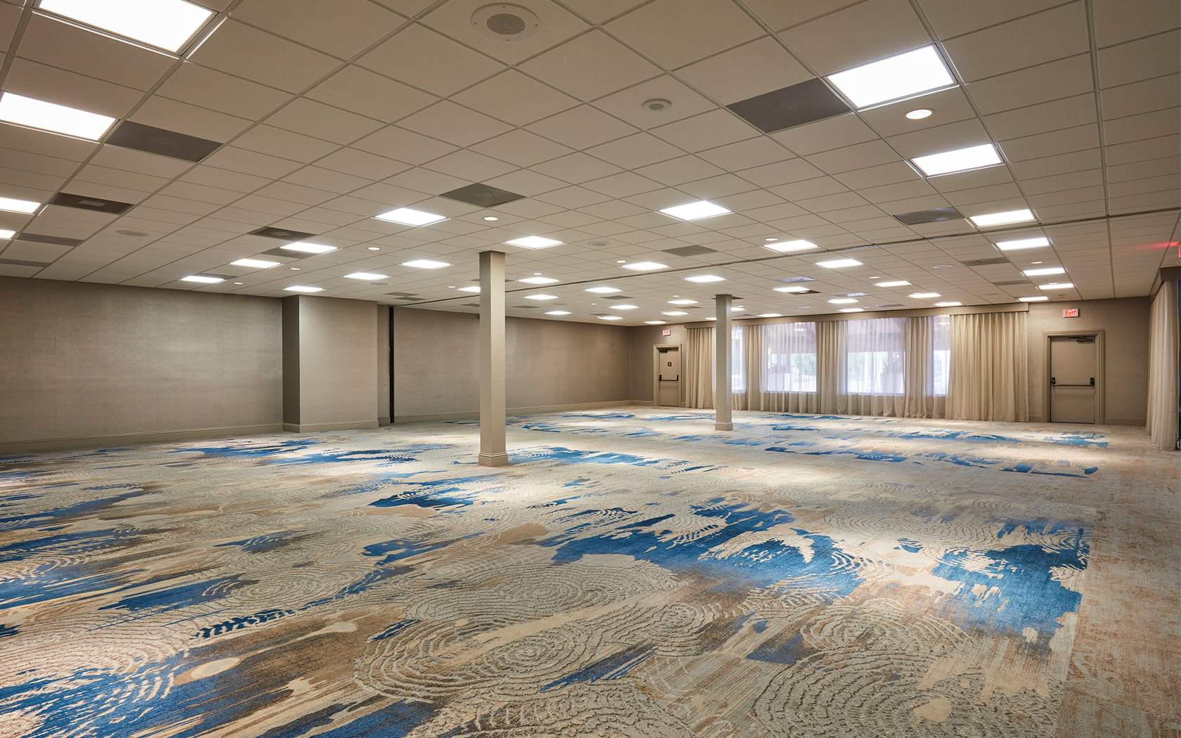 medium sized event space with neutral and blue carpet