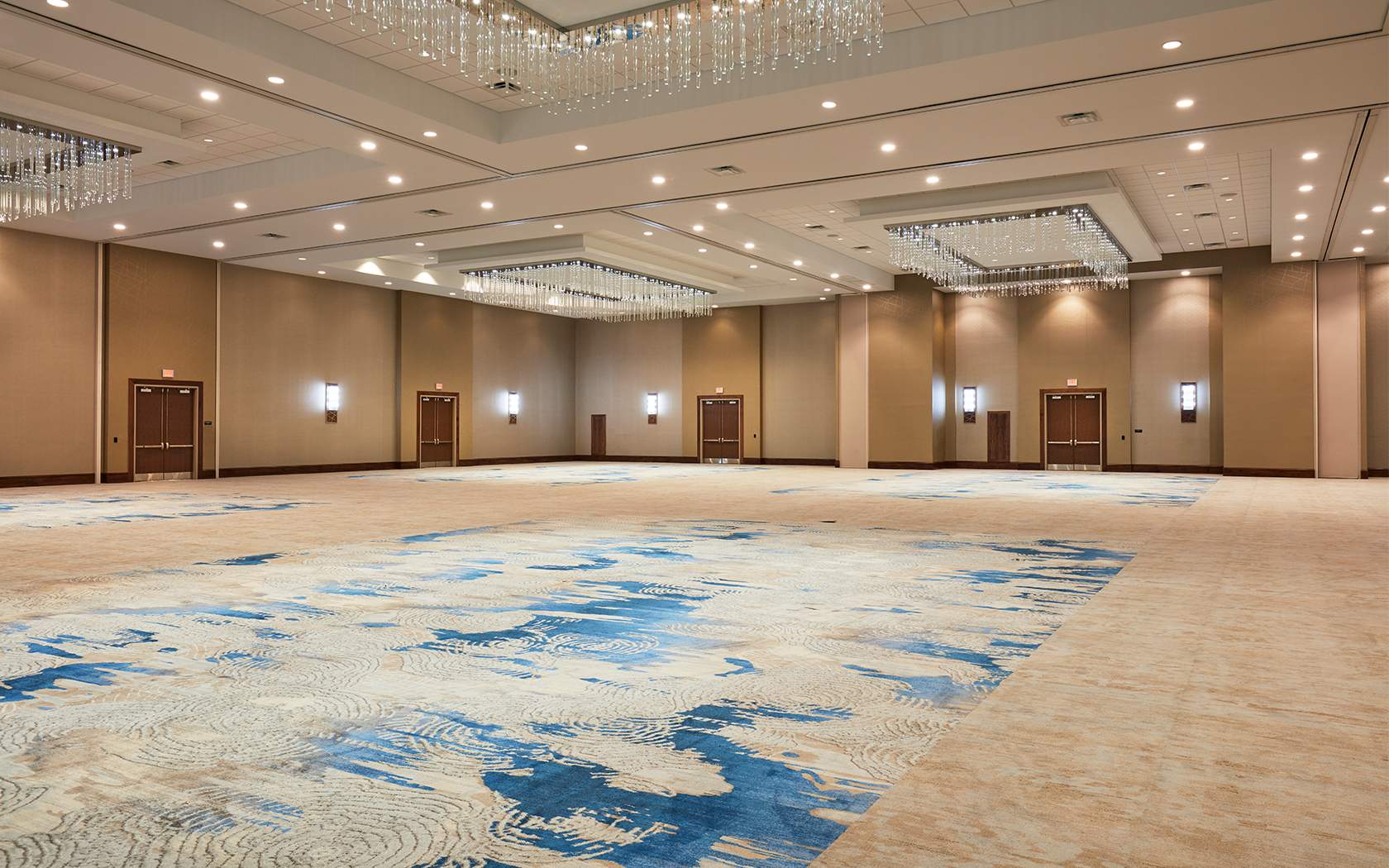 large ball room with neutral colored decor 