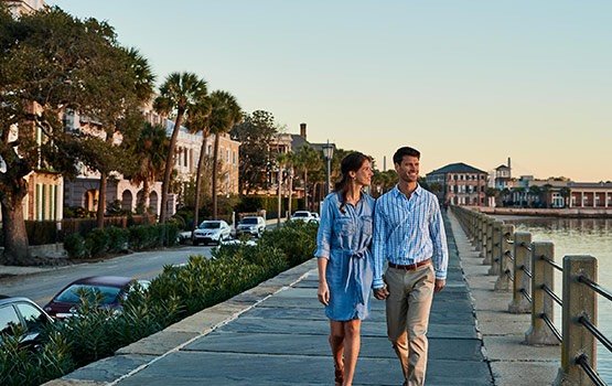 Couple walking hand in hand and admiring the view