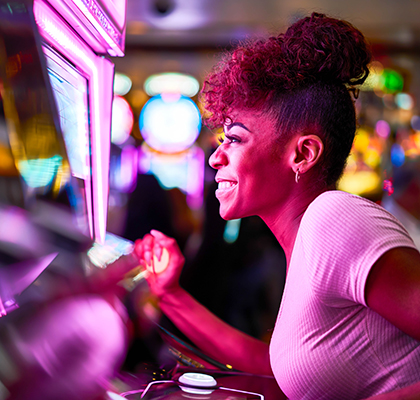 woman playing with a slot machine