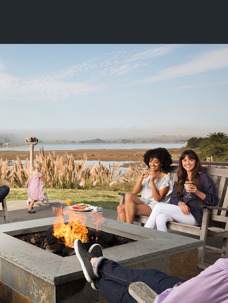 Group of friends gathered around outdoor fire pit