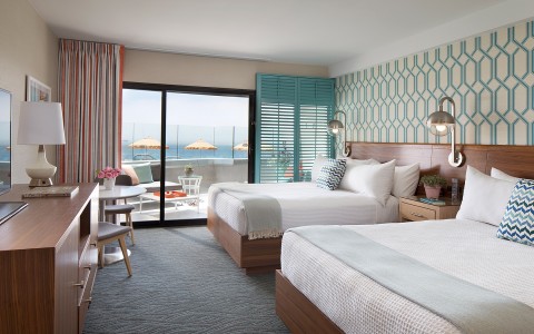 Double queen bedroom with ocean view balcony