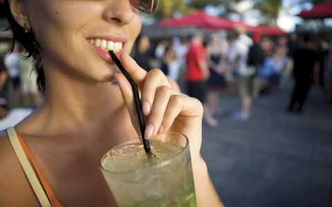 lady sipping on a cocktail at a festival