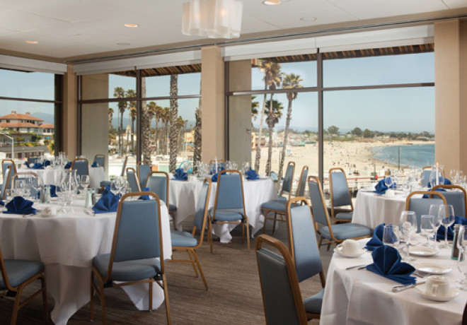 beach-view-room - ballroom with floor to ceiling windows overlooking the beach set with round tables for an event