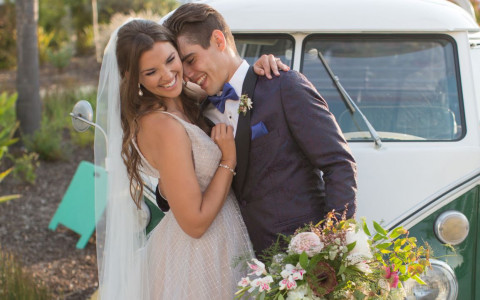 bride and groom posing in front of the vintage van