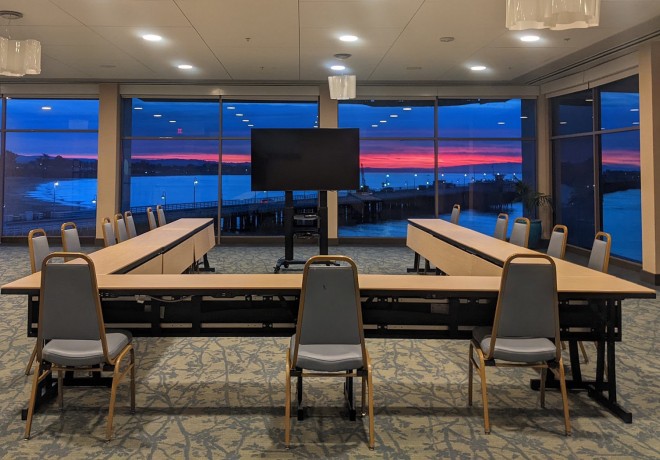 surf-view-room - hotel meeting room overlooking the ocean with a beautiful blue and pink sunset