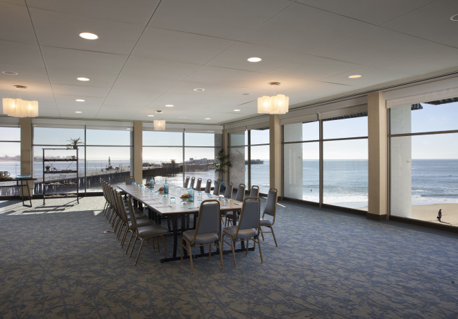 surf-side - event space with floor to ceiling windows overlooking the beach set for a board meeting