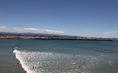 many surfers in shallow water