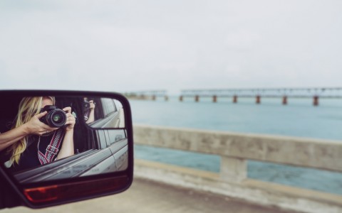 woman photographing a bridge in the flroida keys