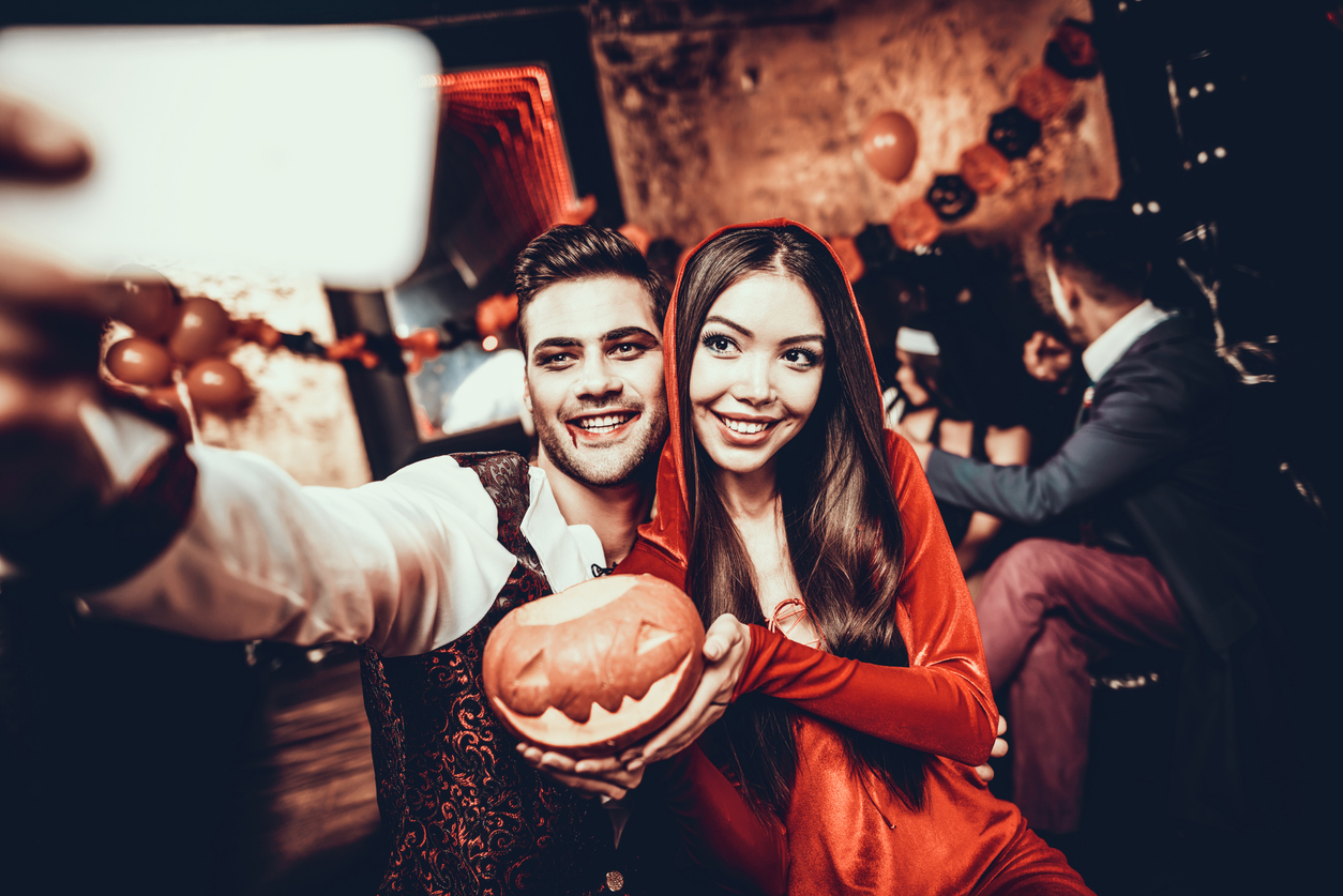 couple in costume taking selfie