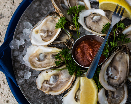oysters on the half shell with lemon and cocktail sauce