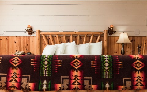 King sized bed with a tribal bed spread 